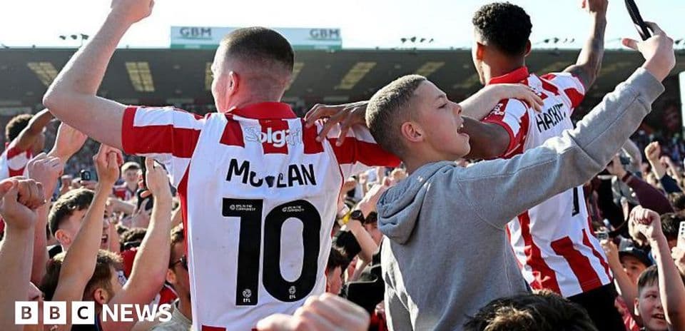 Fans celebrating with players after match victory