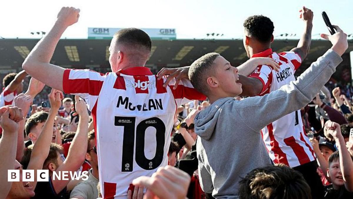 Fans celebrating with players after match victory