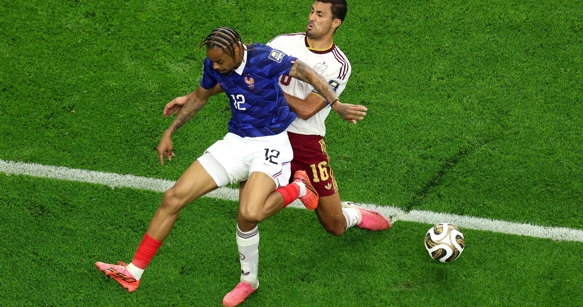 Two players competing for the ball on the field