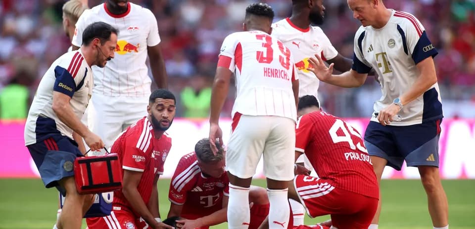 Players and medical staff attending to an injured player