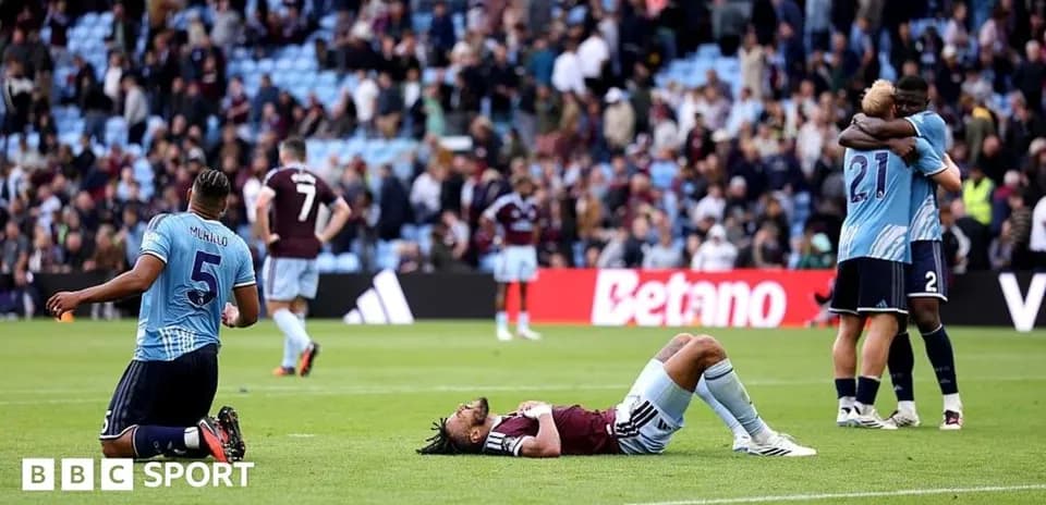Players reacting after match; one on ground