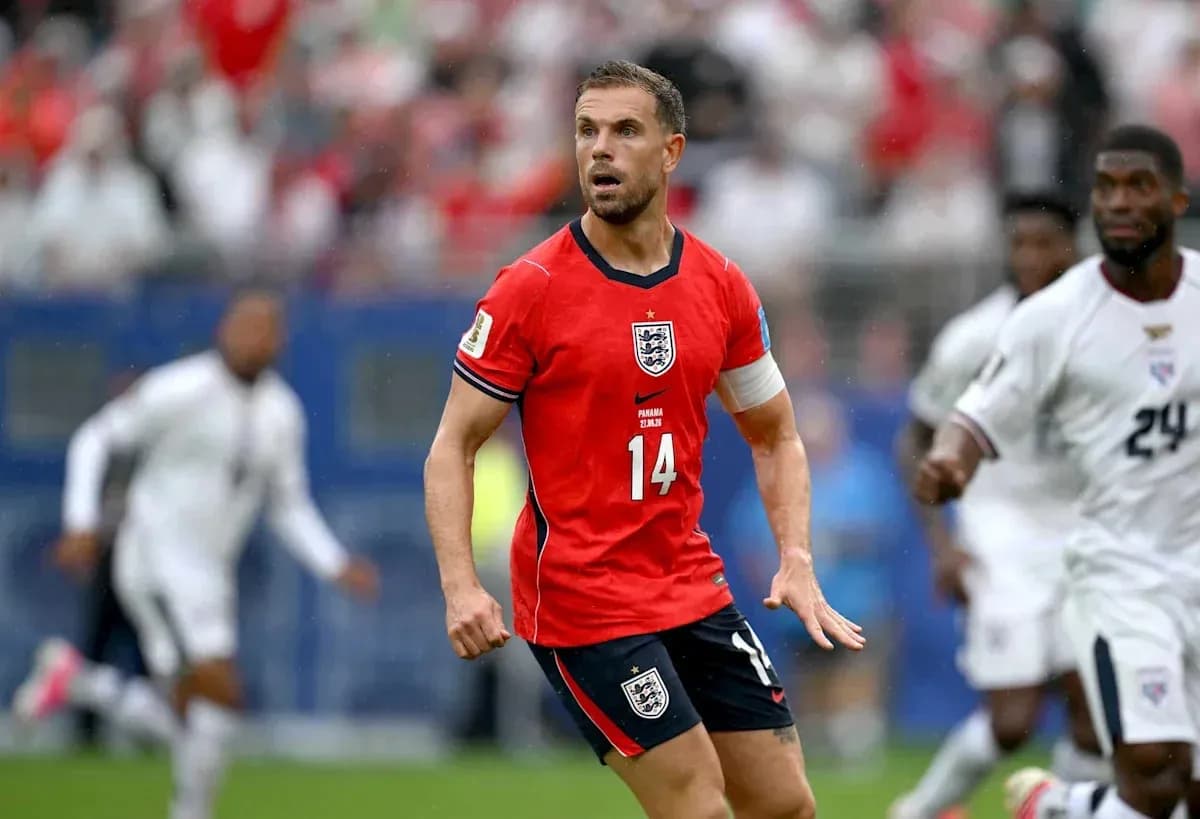 Player in red England kit during match action