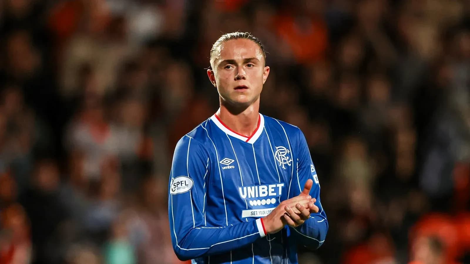 Player applauding fans in Rangers jersey
