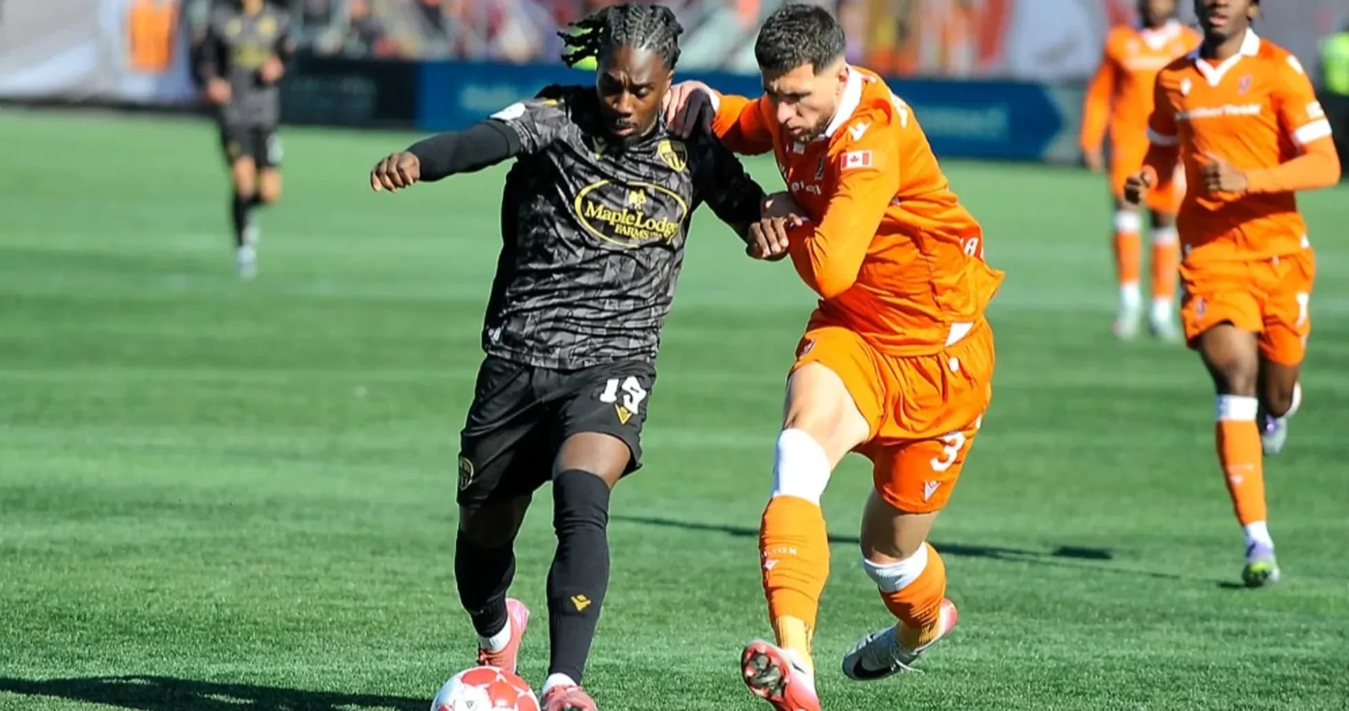 Players competing for the ball in football match