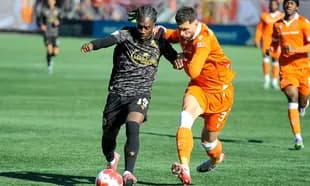 Players competing for the ball in football match