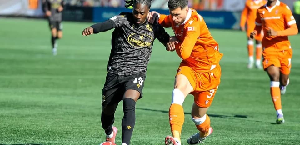 Players competing for the ball in football match