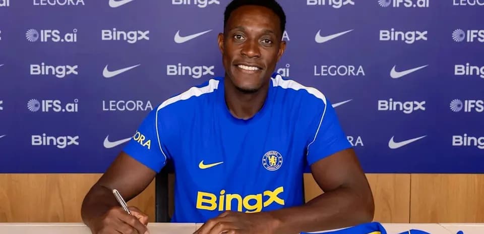 Player signing contract at press conference table