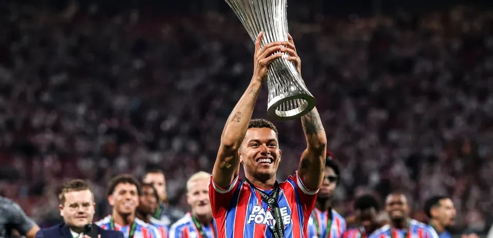 Player celebrating with trophy after winning final