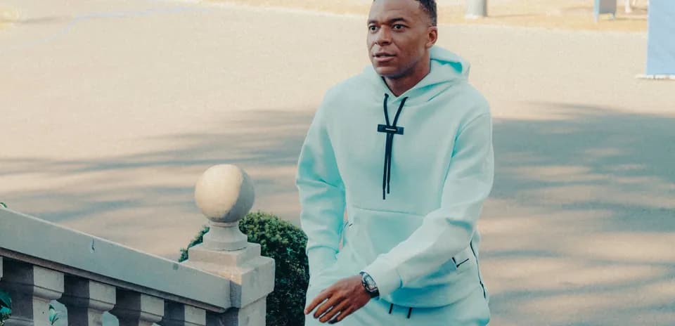 Player walking up steps in light blue tracksuit