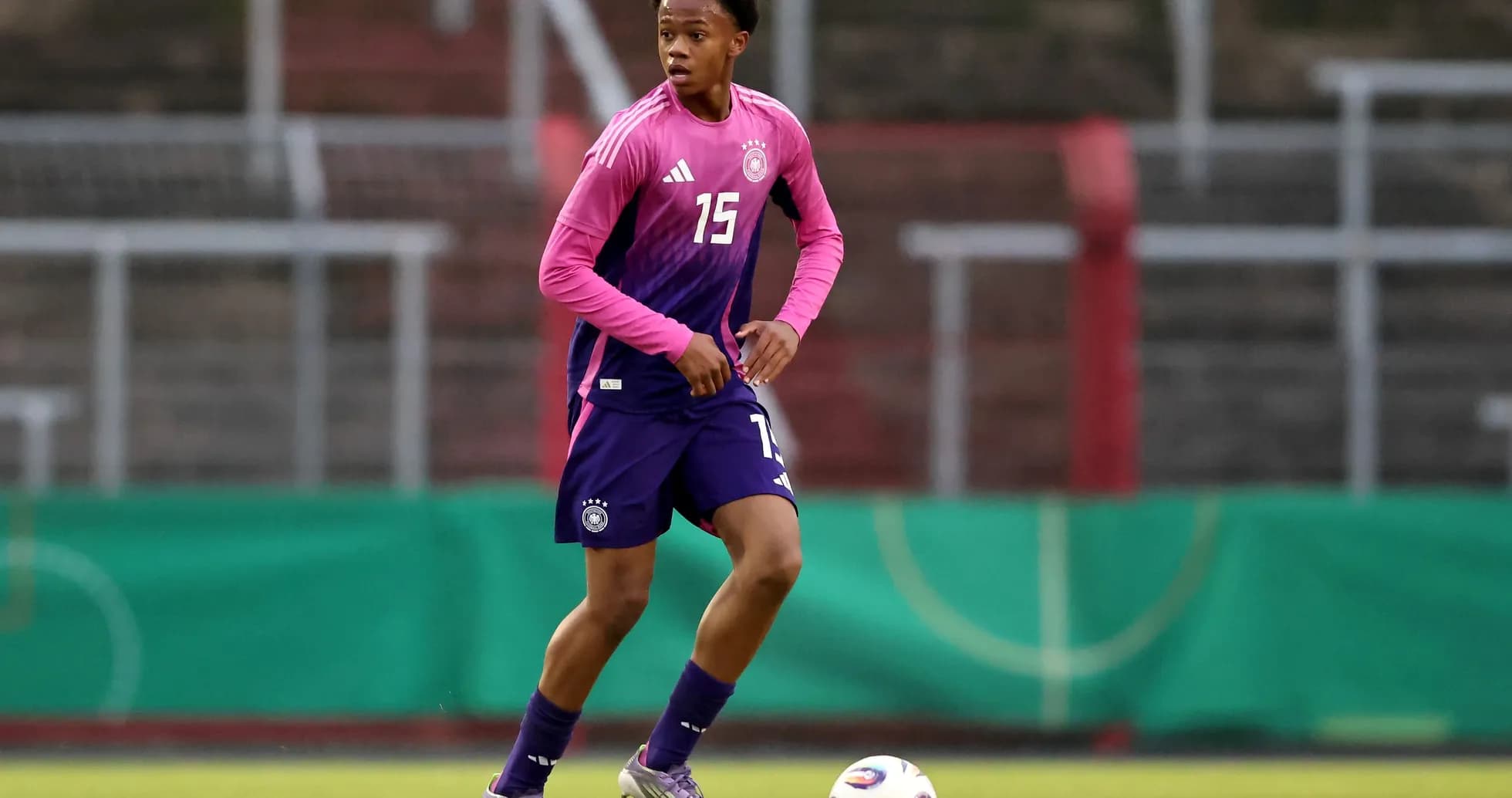 Player in Germany kit dribbling the ball during training
