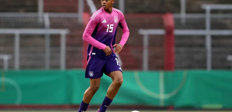 Player in Germany kit dribbling the ball during training