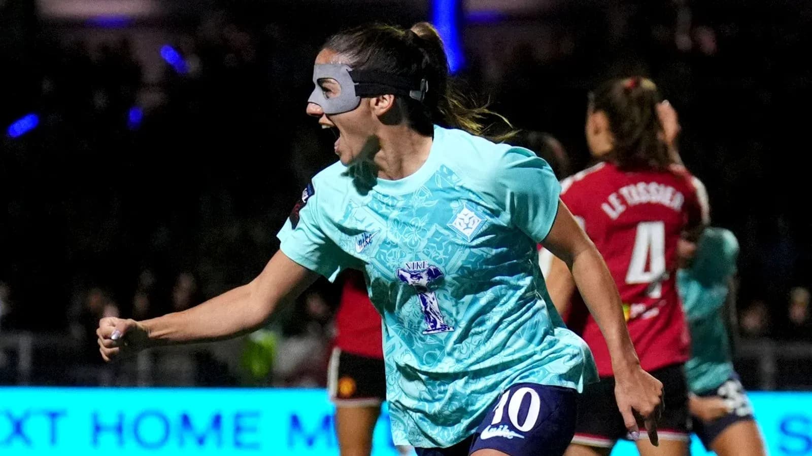 Player celebrating a goal with a mask on