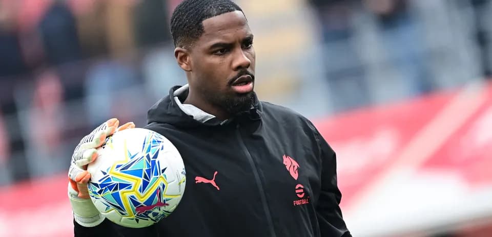 Goalkeeper holding ball during warm-up session