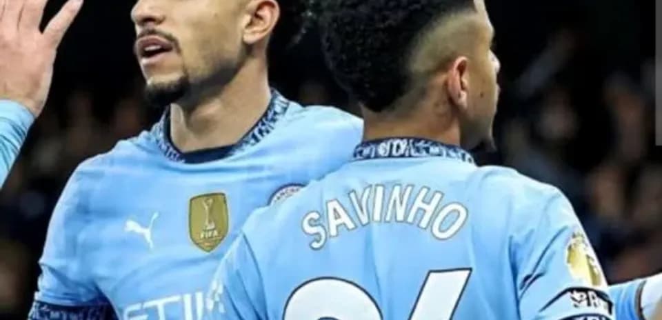 Two Manchester City players celebrating on the field
