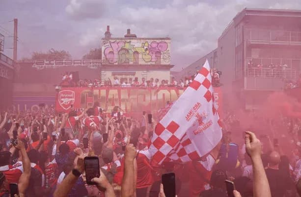 Arsenal fans celebrating with smoke and flags