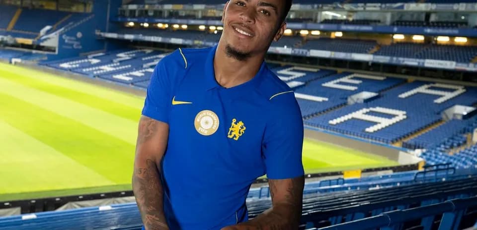 Player posing in Chelsea FC stadium stands