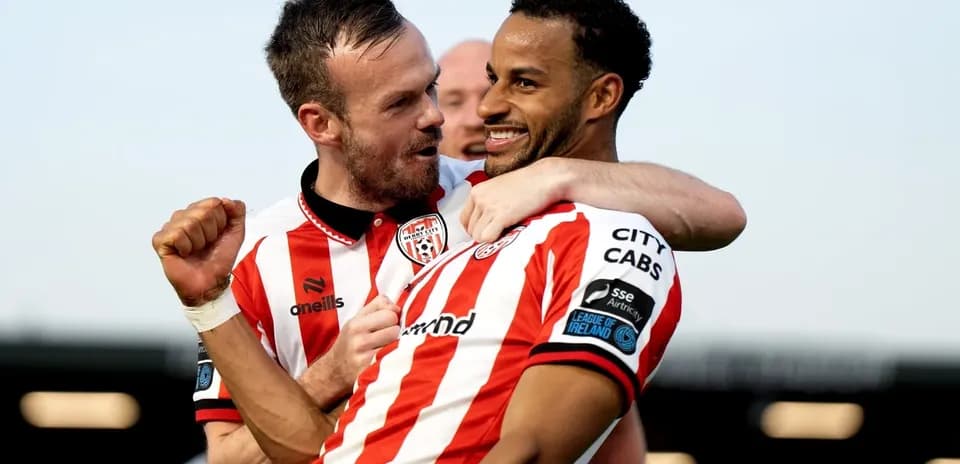Two Derry City players celebrating a goal together