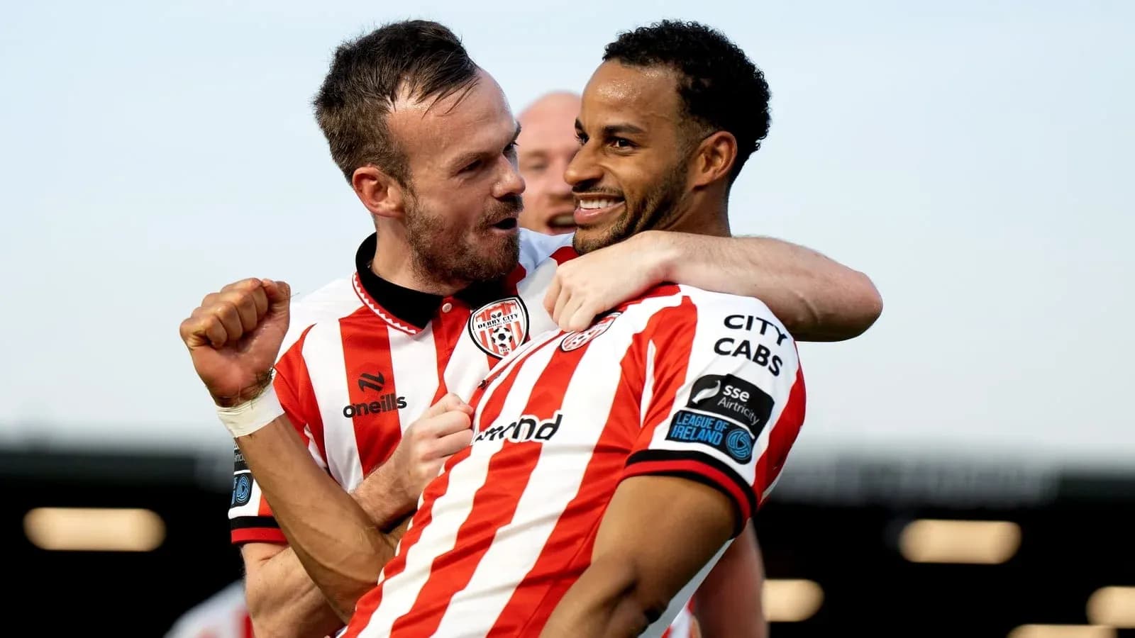 Two Derry City players celebrating a goal together