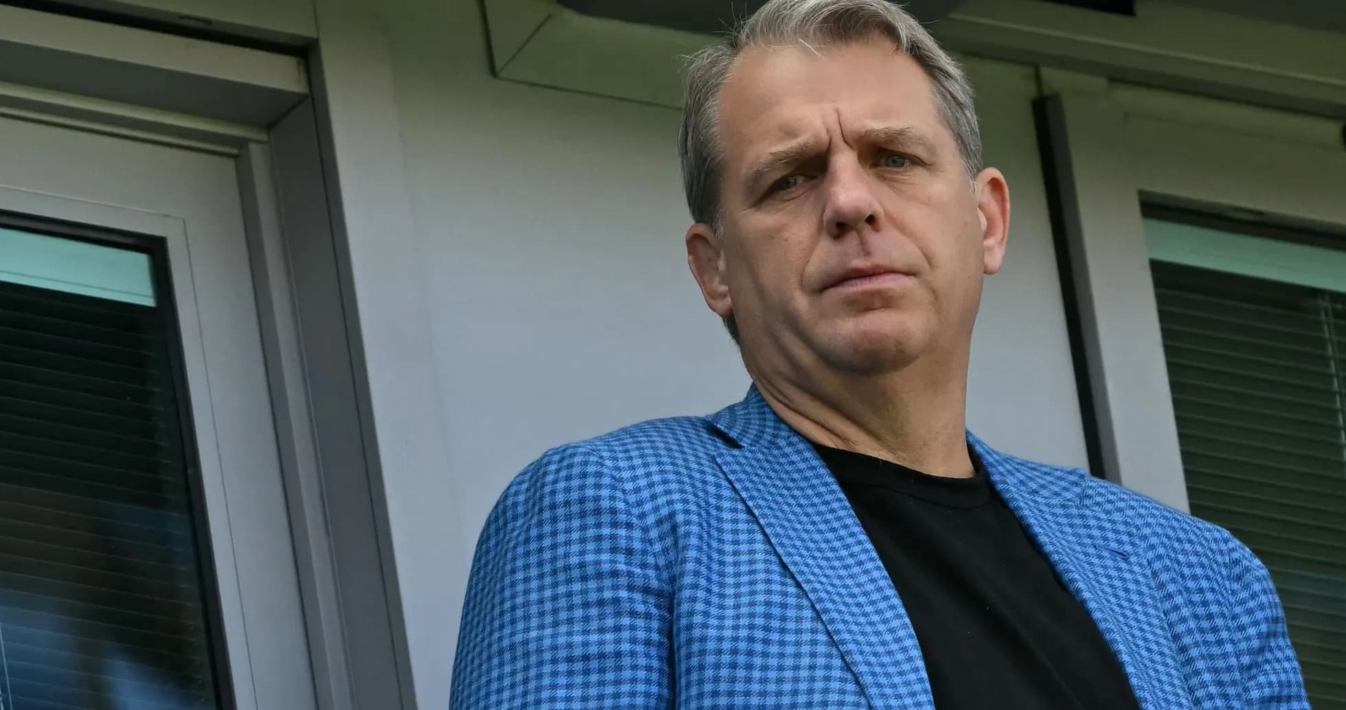 Individual in a blue checked blazer at venue