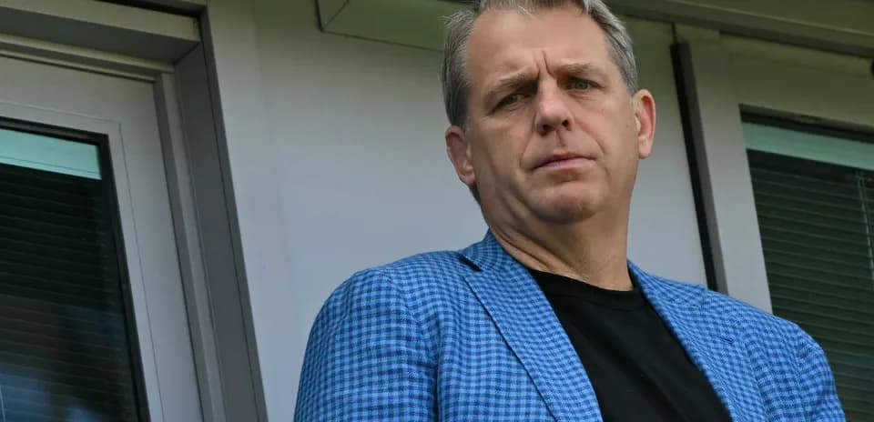 Individual in a blue checked blazer at venue