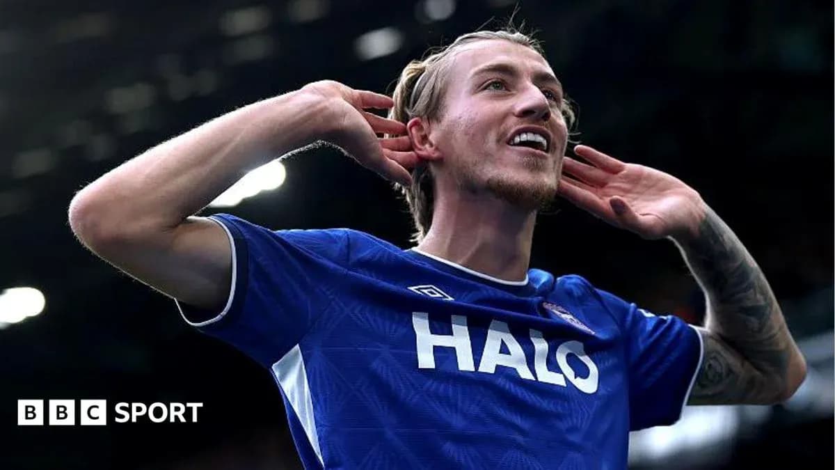 Player celebrating a goal with hands to ears