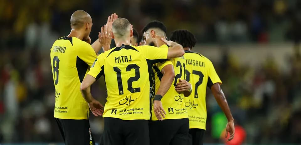 Players celebrating a goal in yellow jerseys