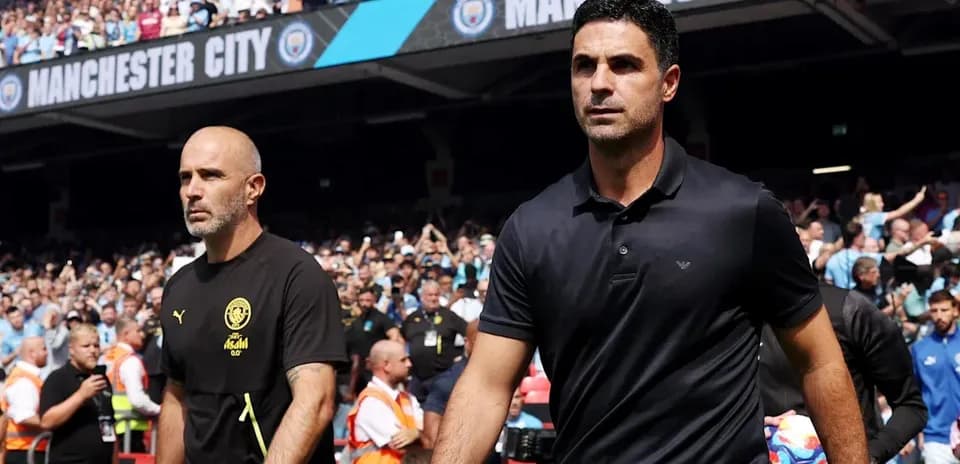 Two managers walking onto the pitch before match