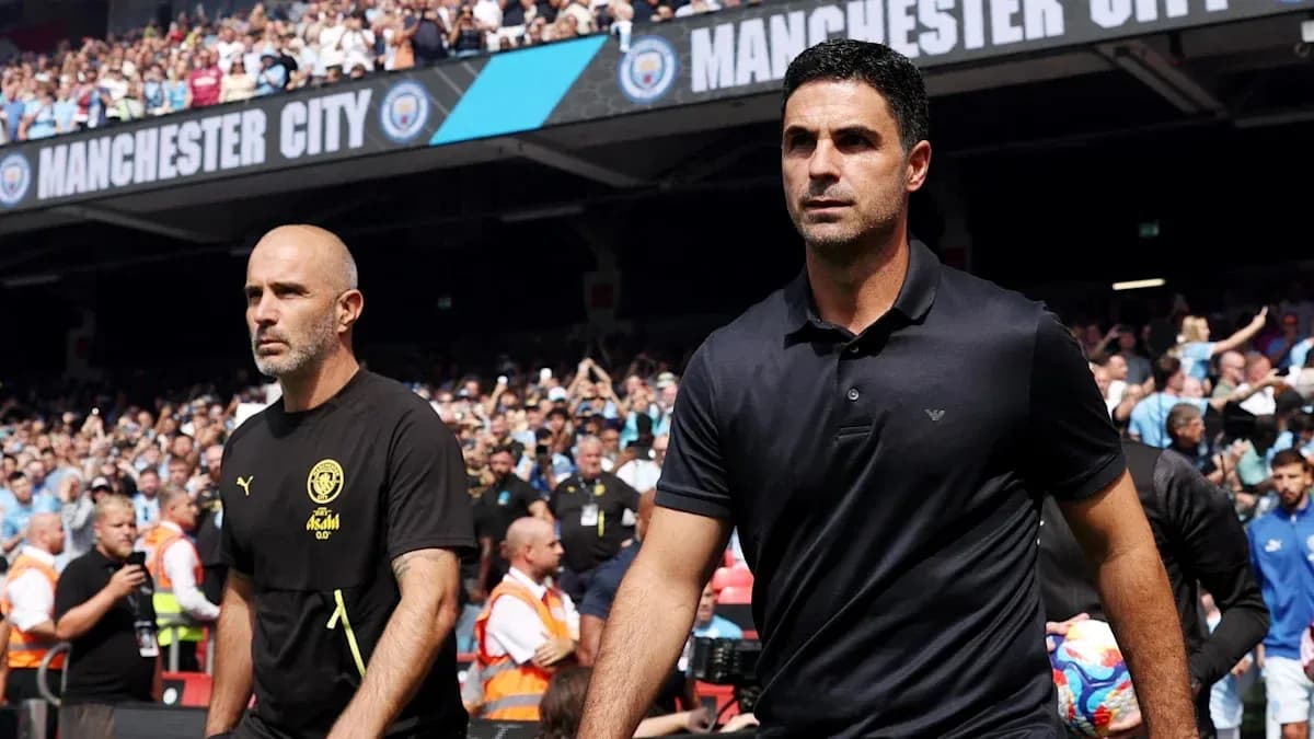 Two managers walking onto the pitch before match