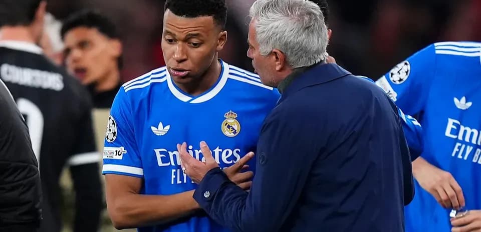Coach discussing strategy with player on field