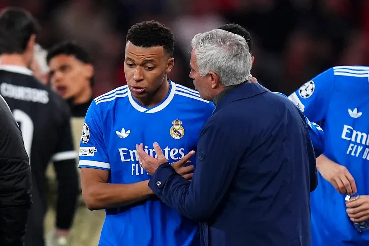 Coach discussing strategy with player on field