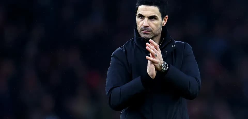 Manager clapping in a dark jacket on field