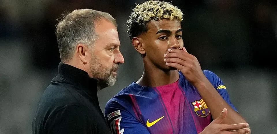 Coach discussing strategy with Barcelona player on field