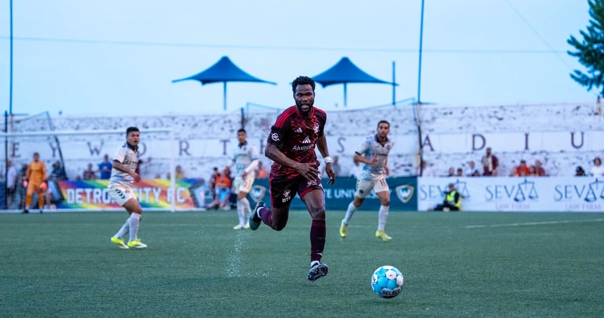 Player dribbling the ball during Detroit City match