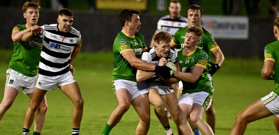 Players competing for possession during a Gaelic football match