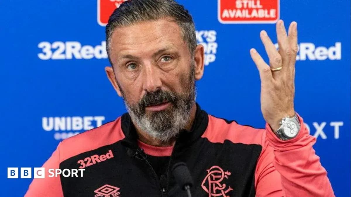 Manager speaking at press conference with hand raised