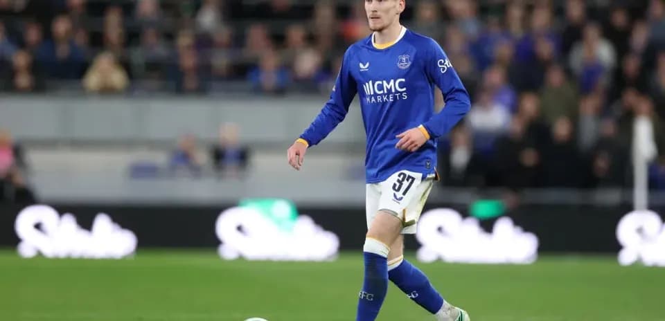 Player wearing blue kit walking on the pitch