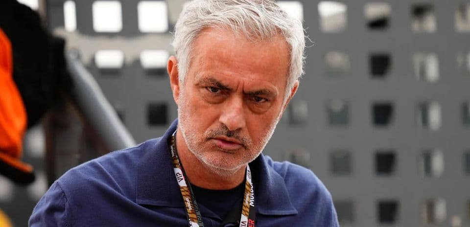 Coach in a blue shirt with a serious expression