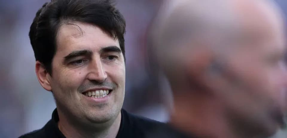 Man smiling with another person in background