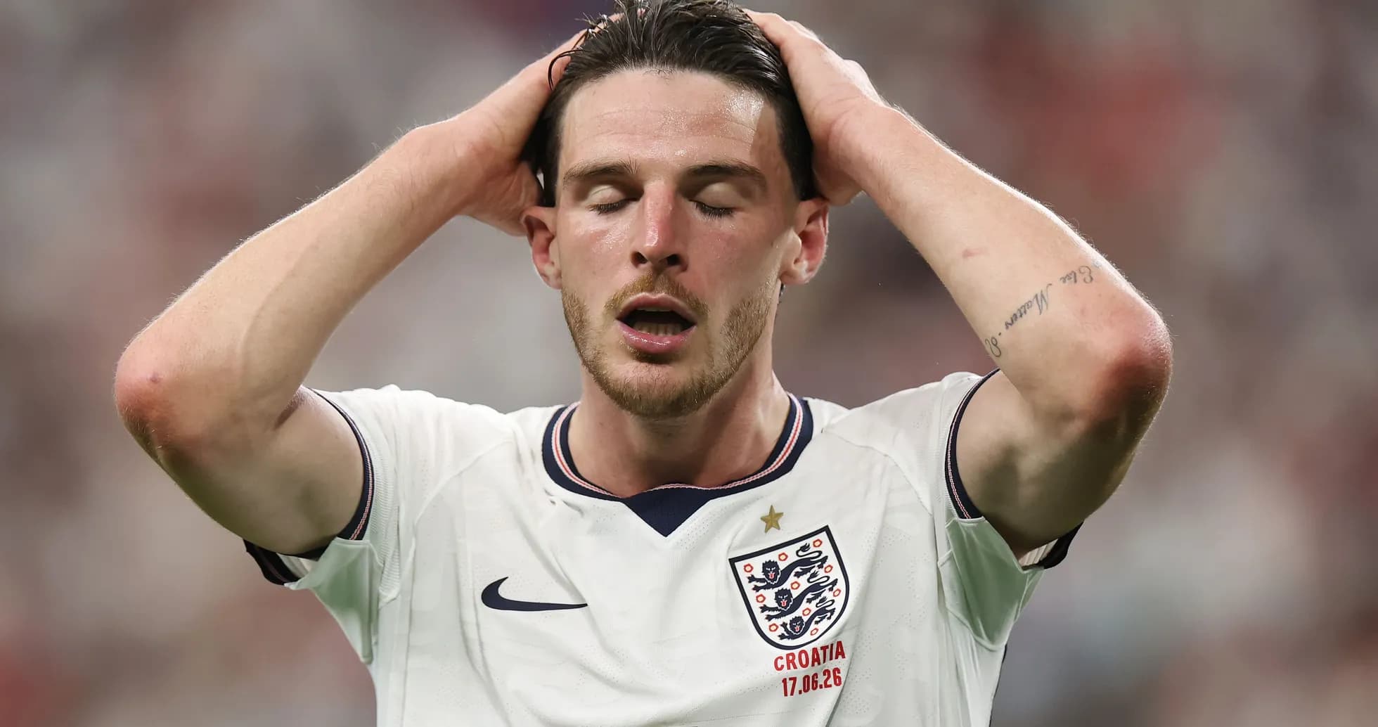 Player holding head in disappointment on field