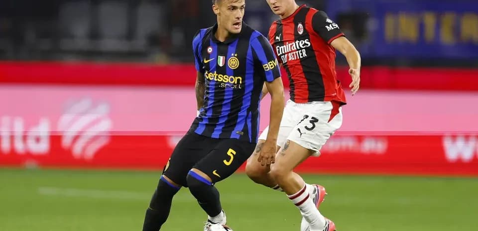 Player dribbling the ball during match between teams
