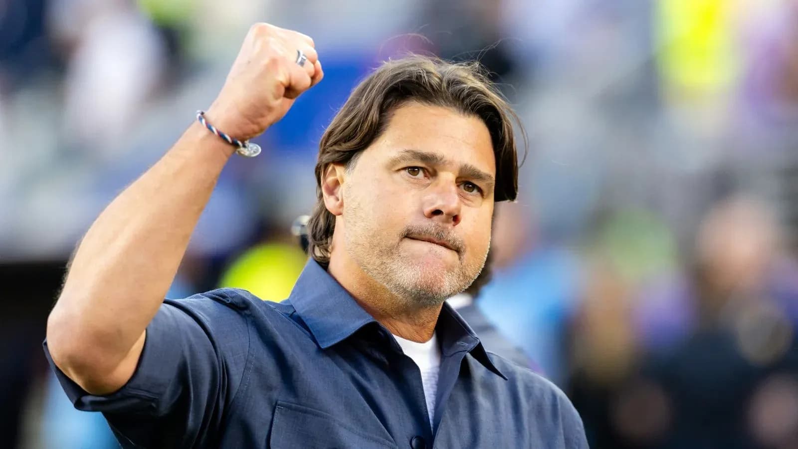 Coach celebrating with raised fist during game