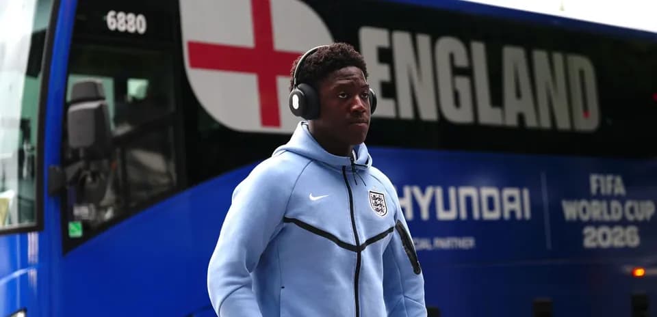 Player walking past England team bus before match