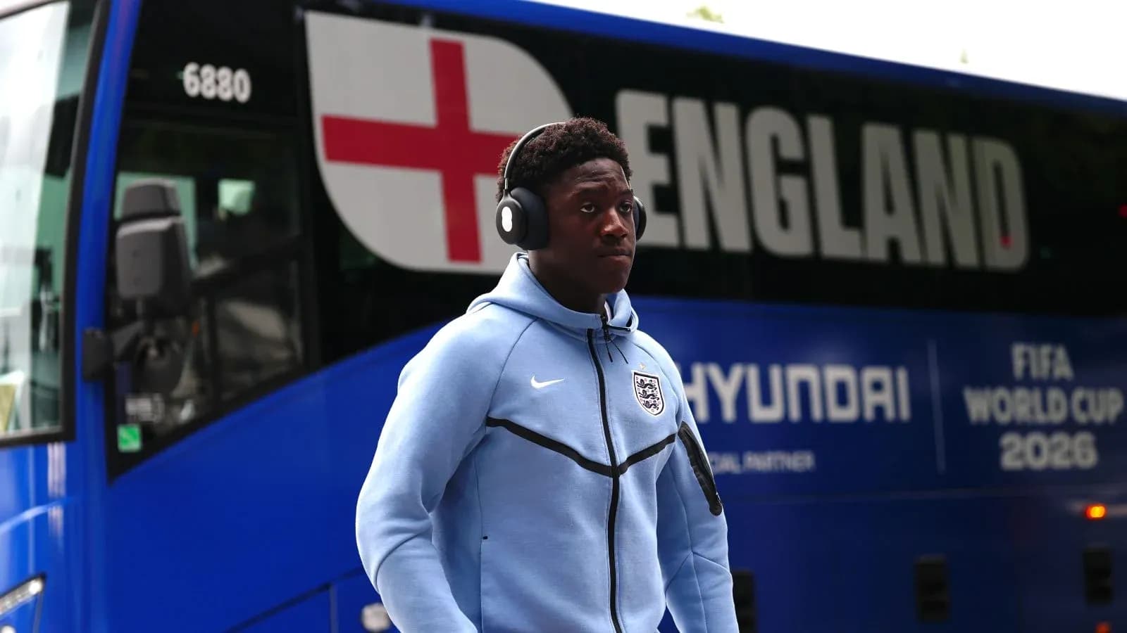 Player walking past England team bus before match