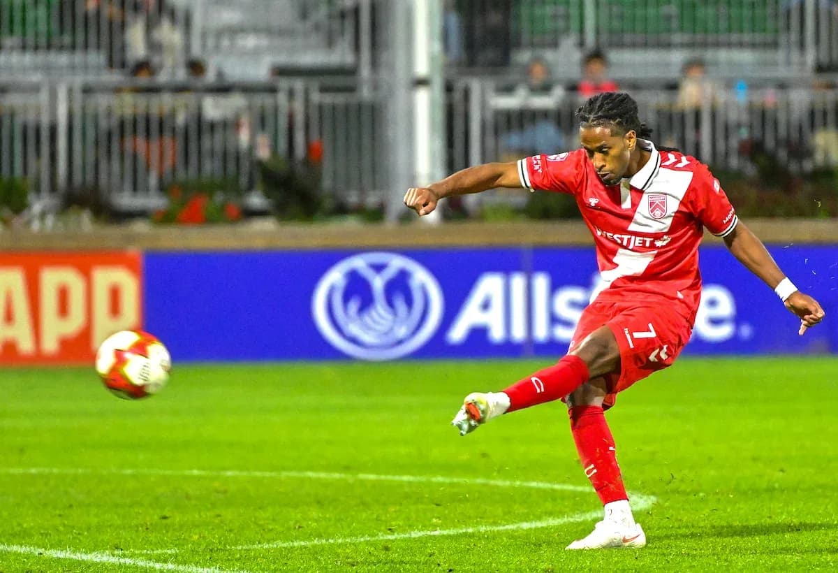 Player kicking the ball during Cavalry FC match