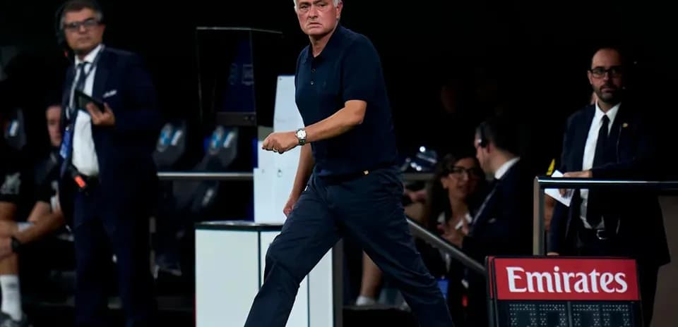 Manager walking along the sideline during match