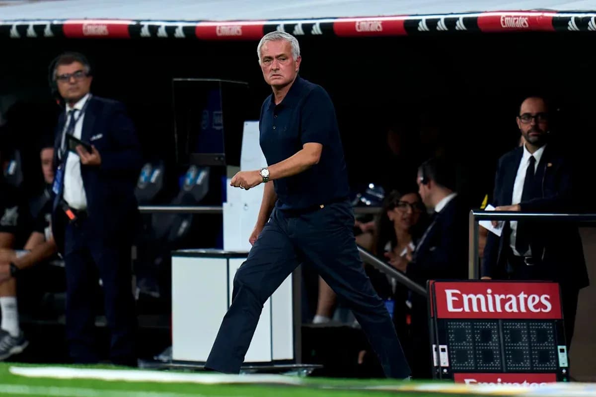 Manager walking along the sideline during match