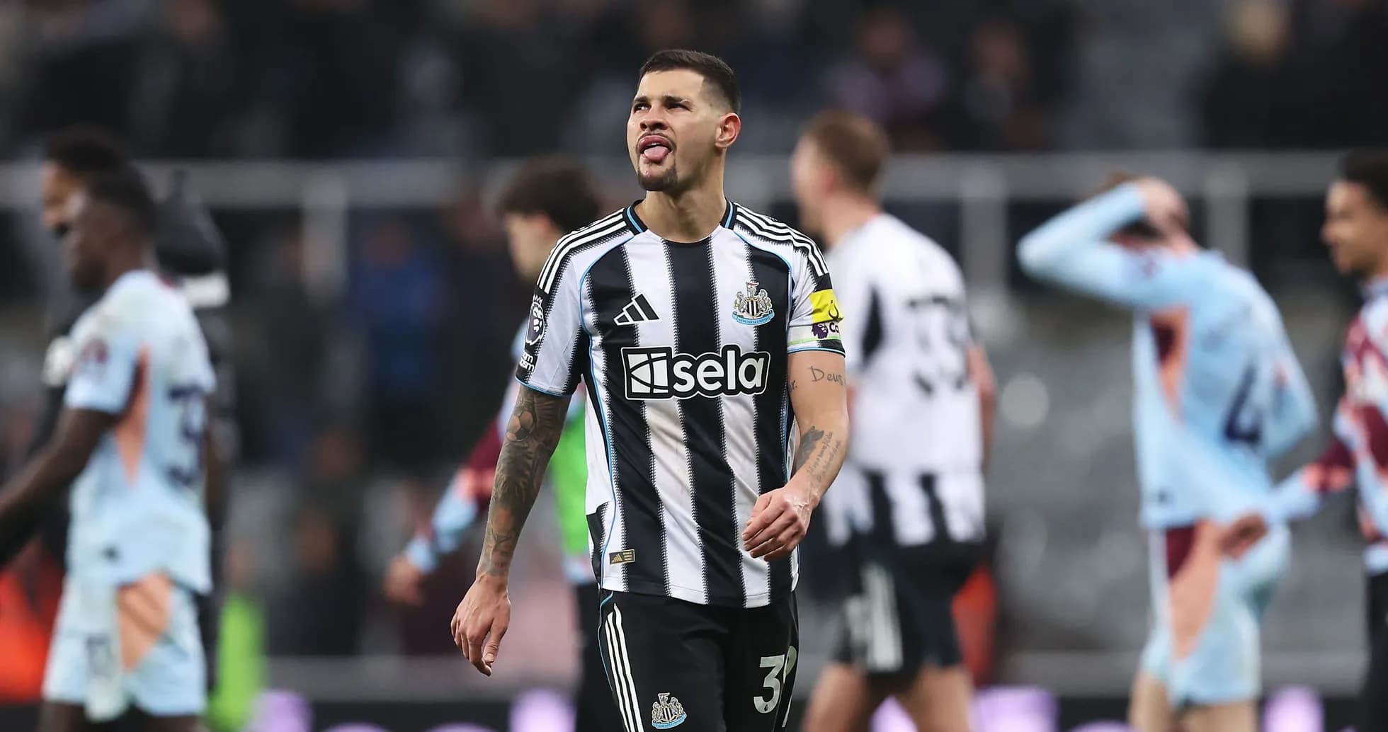 Newcastle player walking off the pitch after match