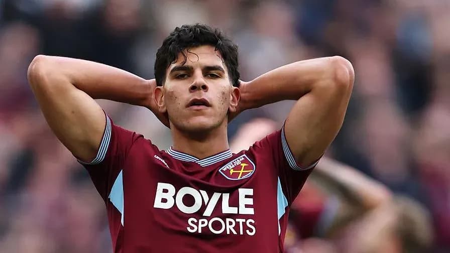 Player in claret jersey with hands on head