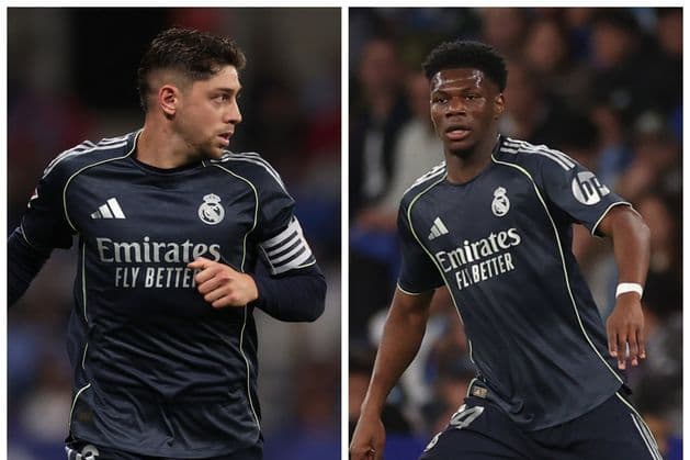 Two Real Madrid players in dark jerseys during match