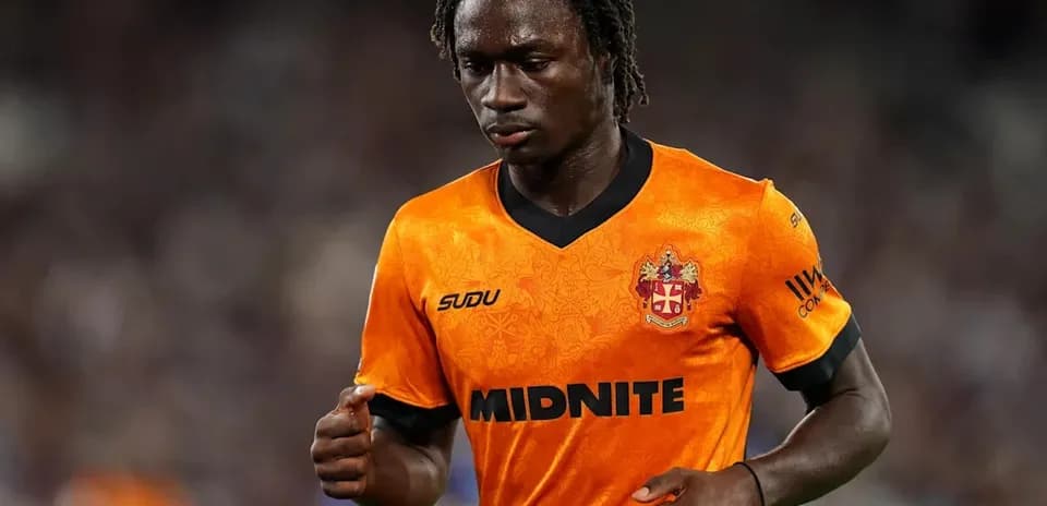 Player in orange jersey walking on the field
